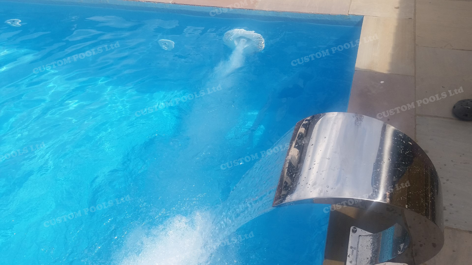 Made to order fibreglass pool with waterfall and swim jet